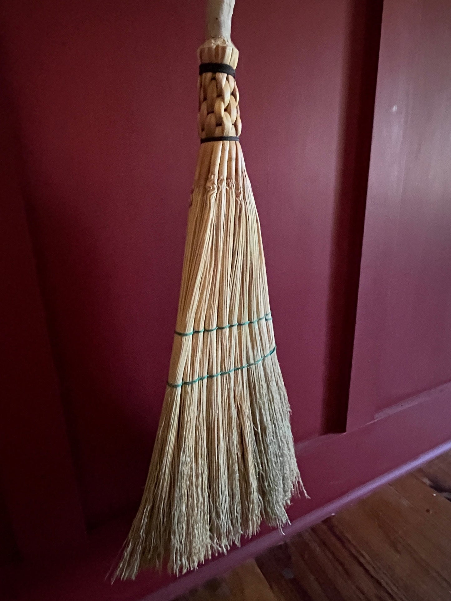 Handmade broomcorn broom on a Paper Birch tree branch broomstick