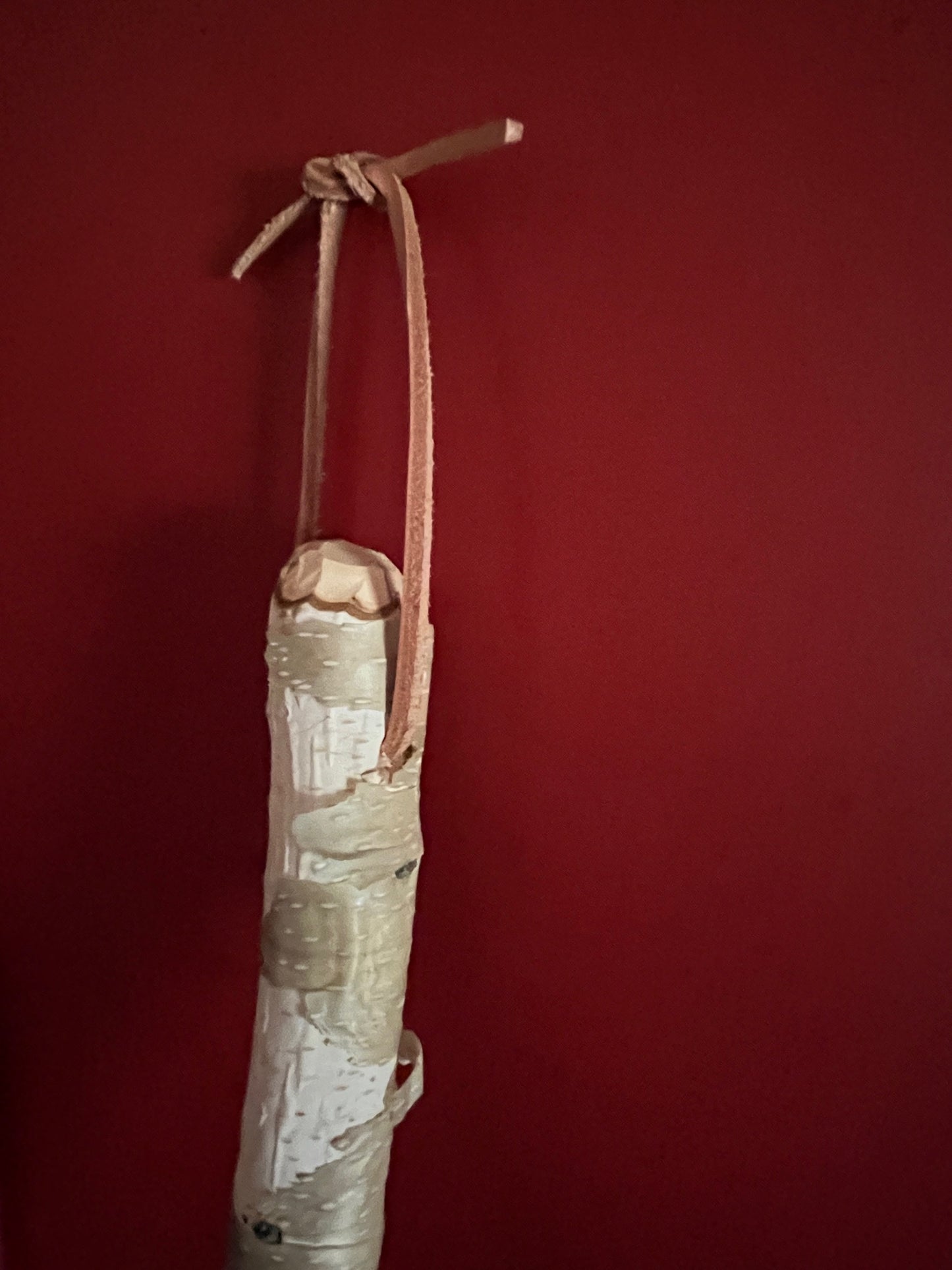 Handmade broomcorn broom on a Paper Birch tree branch broomstick