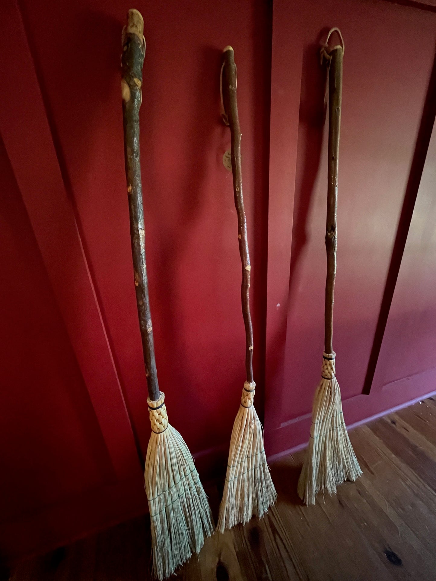 Handmade broomcorn broom on a tree branch broomstick
