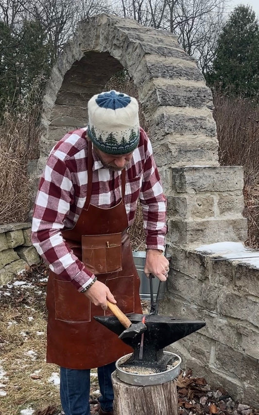 Our blacksmith work goes on outside in cold weather!